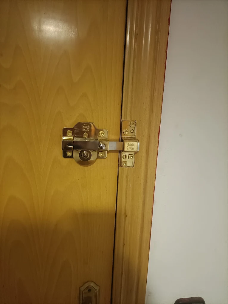 Resultado final de una instalacion de cerradura de seguridad tipo cerrojo en puerta de madera